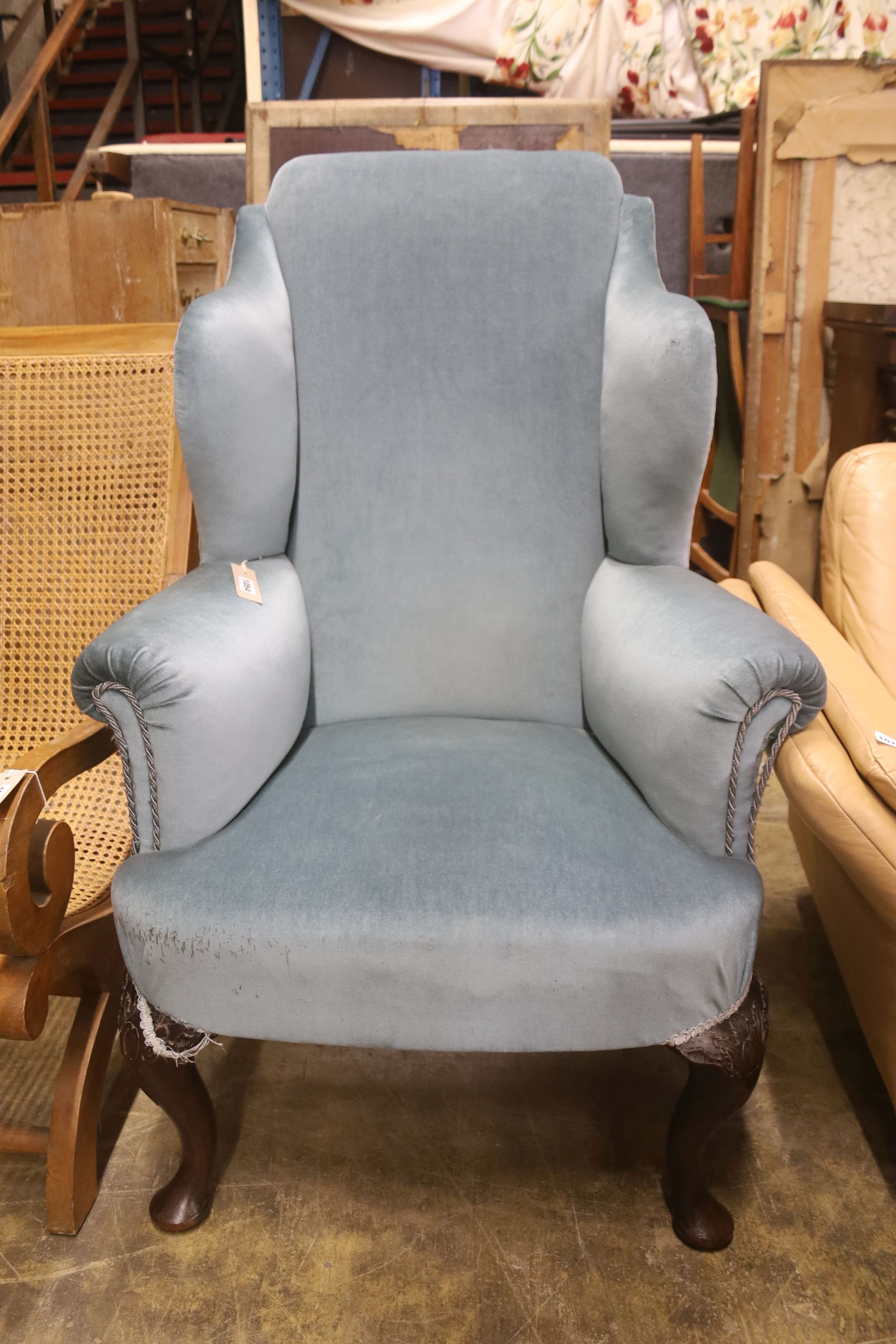 A 1920's Queen Anne style upholstered wing armchair, width 80cm, depth 70cm, height 121cm